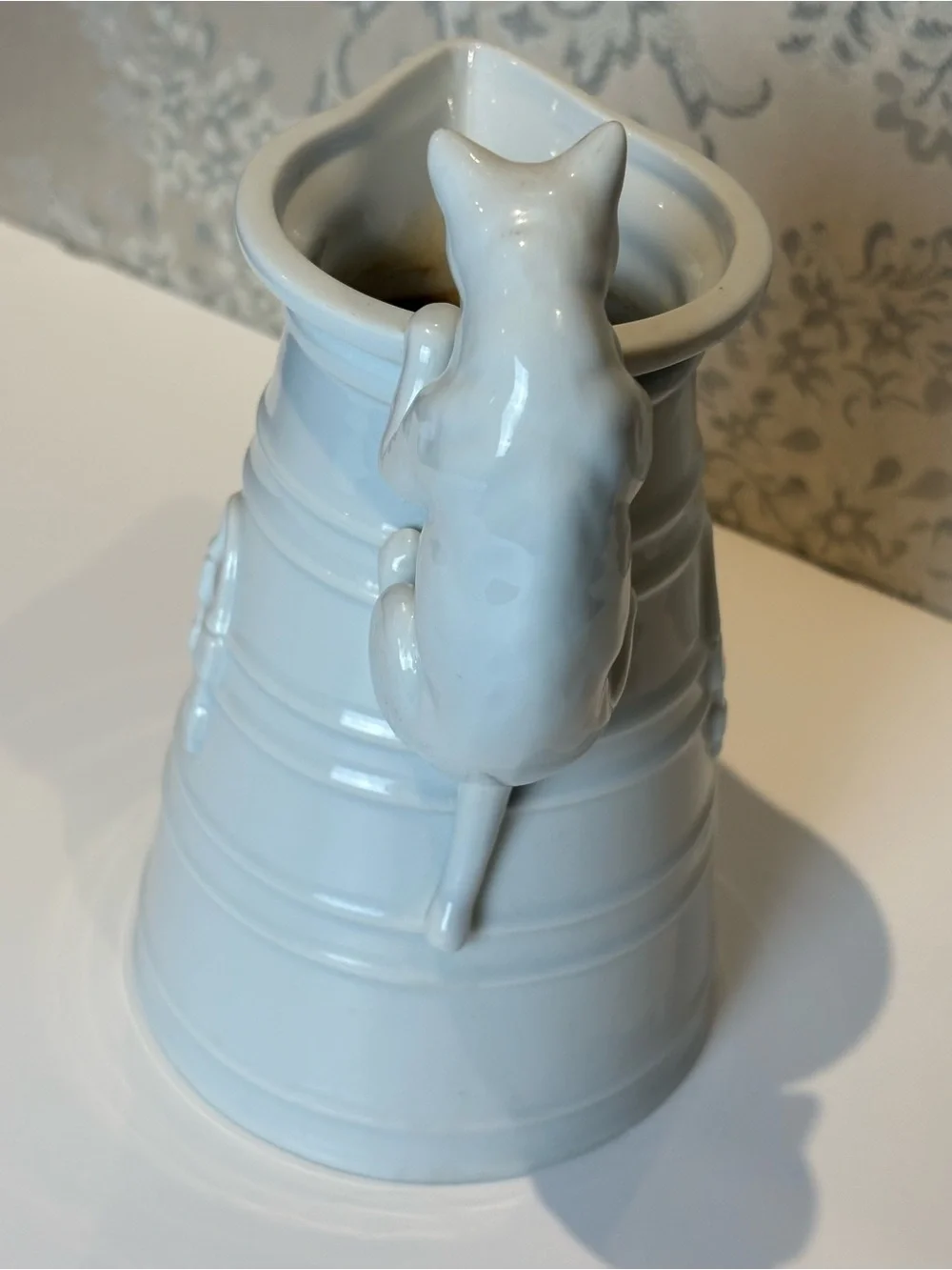 Vintage White Porcelain pitcher with a cat as a handle. Holds 20oz.